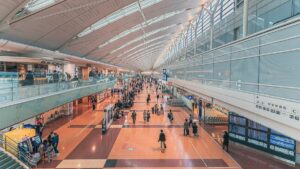 大勢の旅行者が行き交う日本の空港ターミナルの出発ロビー